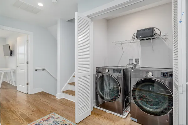 a view of a hallway with washer and dryer
