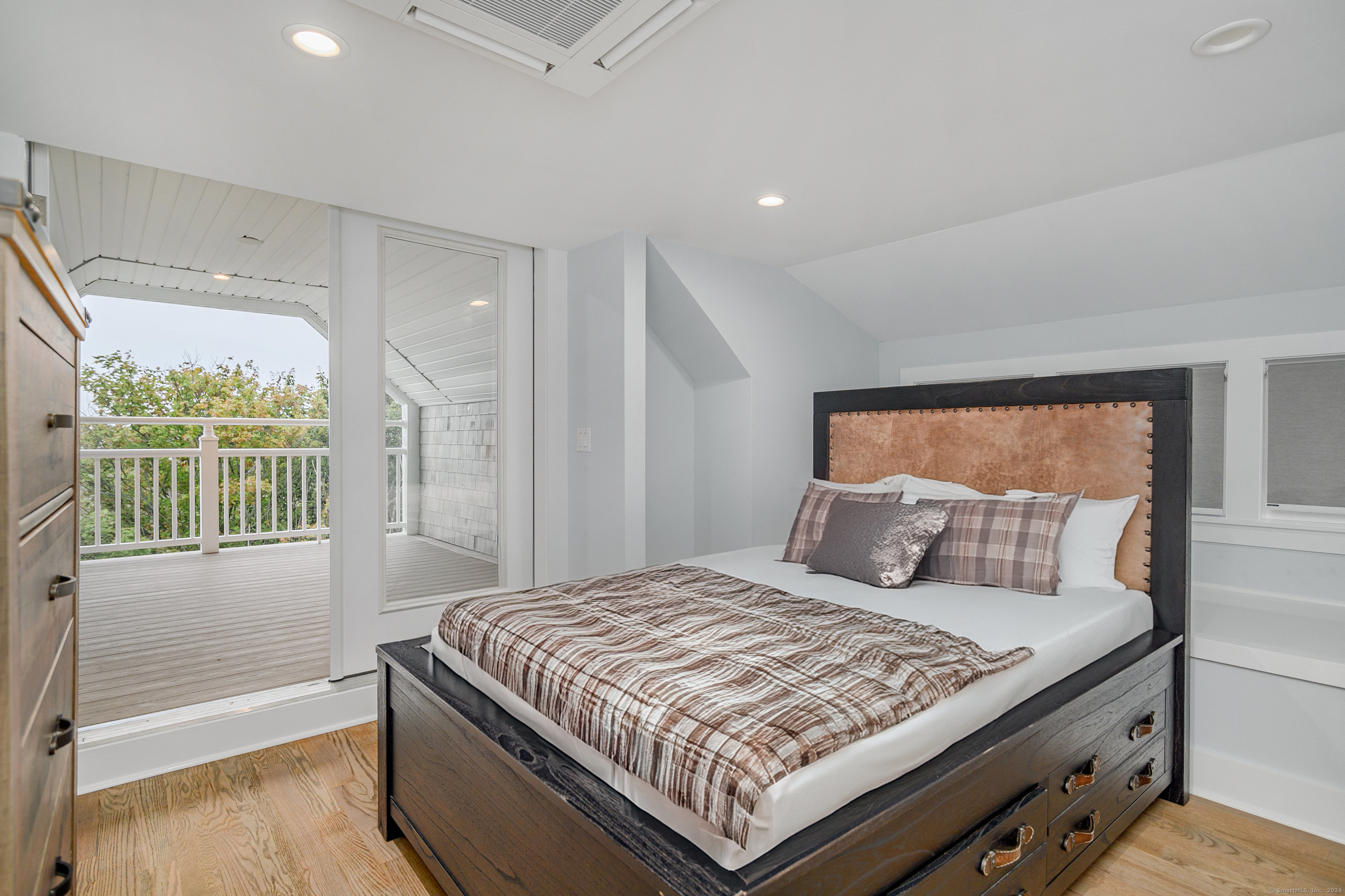 1039 Reef Road Fairfield, CT 06824 - Photo 20 of 26 a bedroom with a large bed and a window