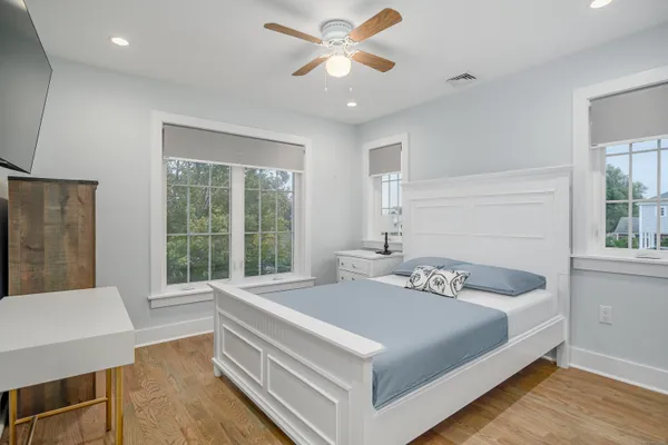 a bedroom with a bed and a large window