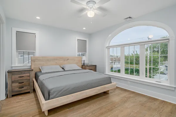a bedroom with a large bed and a large window