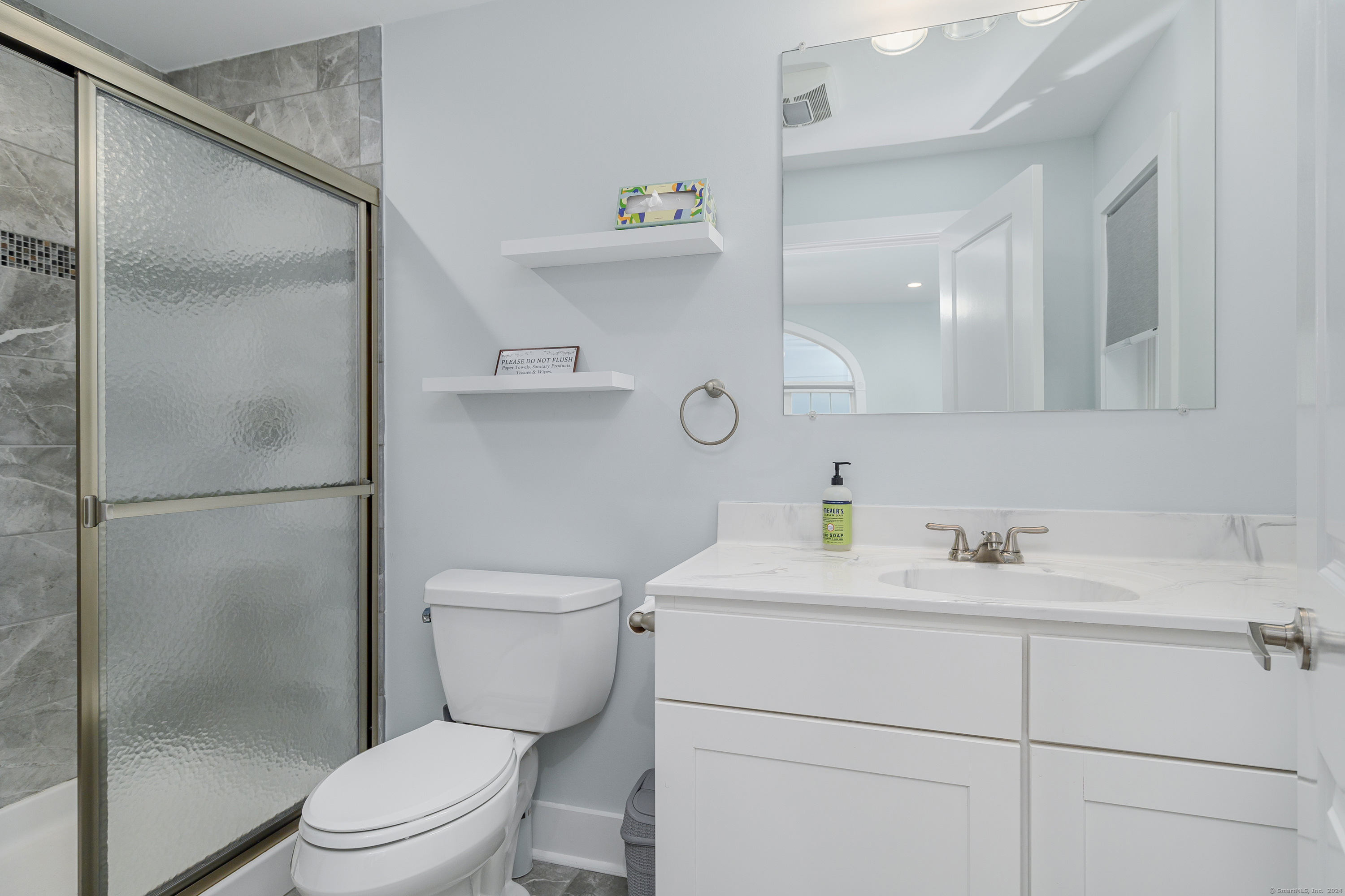 1039 Reef Road Fairfield, CT 06824 - Photo 26 of 26 a bathroom with a toilet sink vanity and shower