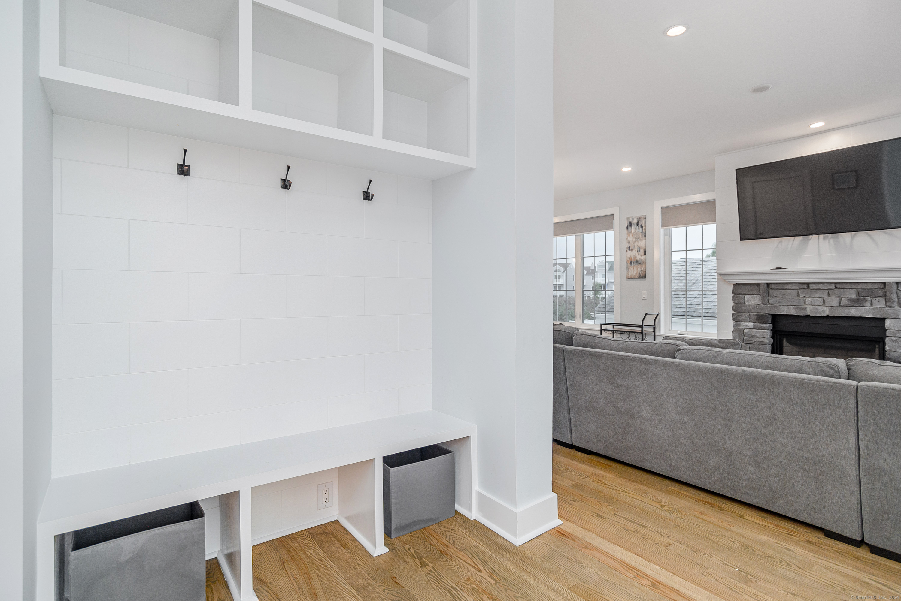 1039 Reef Road Fairfield, CT 06824 - Photo 3 of 26 a living room with a fireplace and a flat screen tv