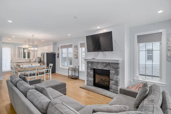 a living room with furniture fireplace and flat screen tv