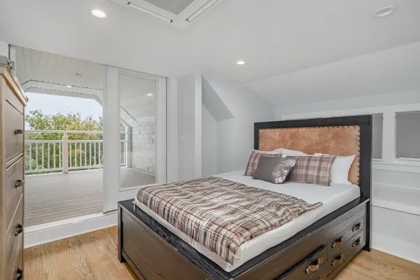 a bedroom with a large bed and a window