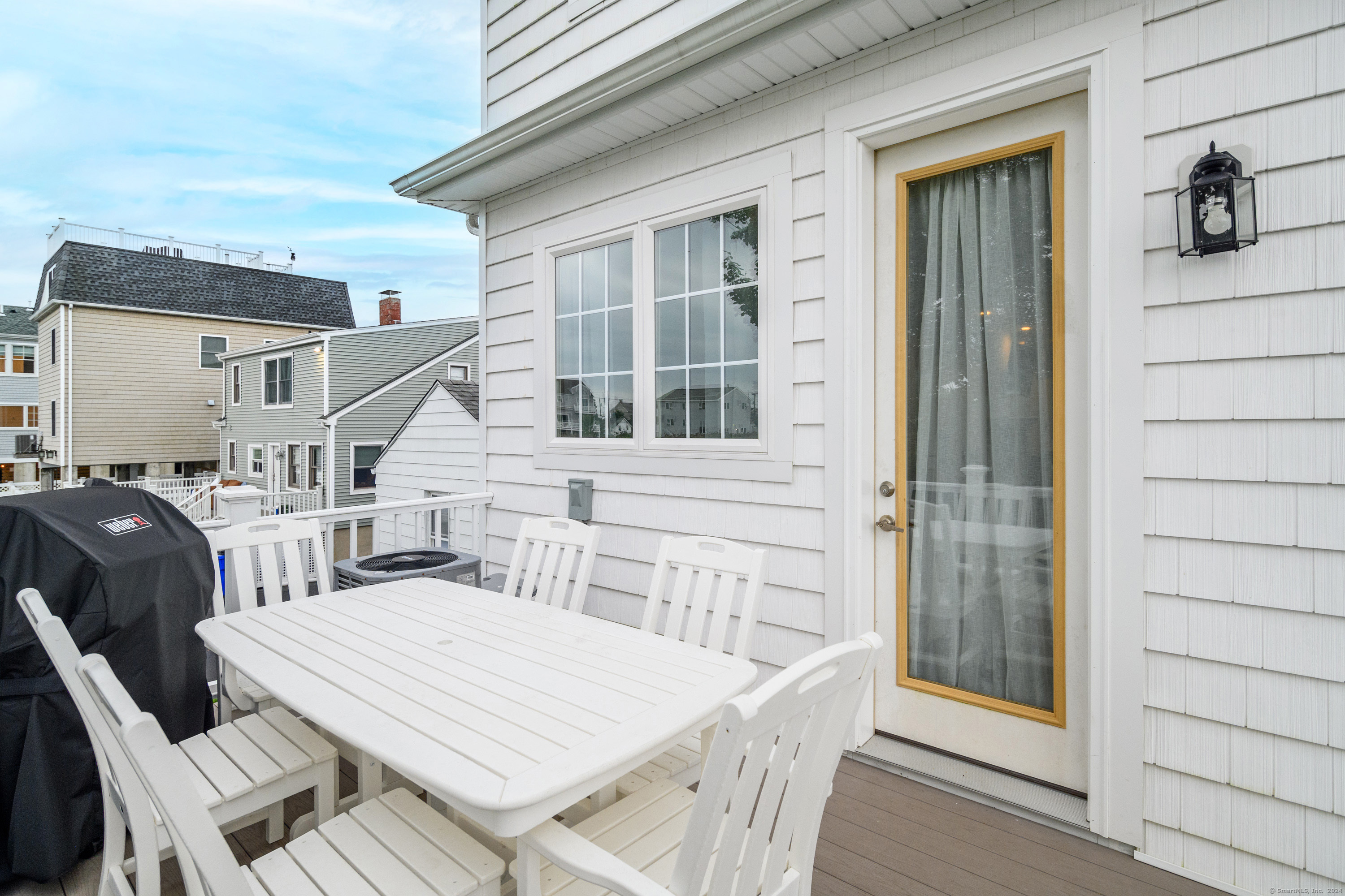1039 Reef Road Fairfield, CT 06824 - Photo 10 of 26 a view of a patio with table and chairs
