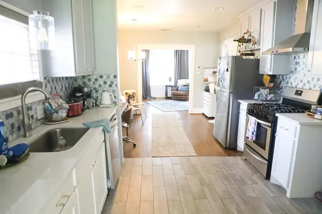 a kitchen with a sink stove and refrigerator