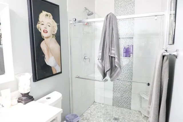 a bathroom with a sink toilet and shower