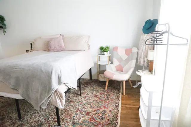 a bed room with a bed and a chair