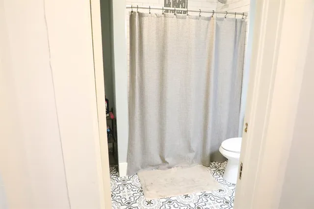a view of a bathroom with a shower curtain