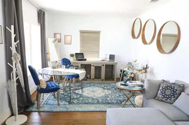 a dining room with furniture a rug and wooden floor