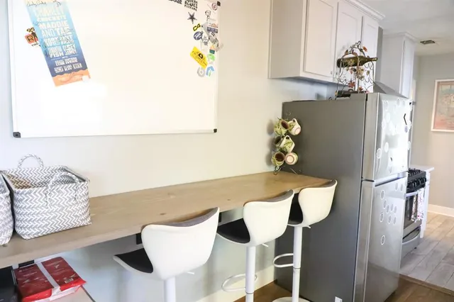 a dining room with furniture and a chandelier