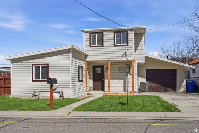 636w 4th Avenue Midvale, UT 84047 - Photo 1 of 1 Traditional-style house featuring a porch, a garage, and concrete driveway