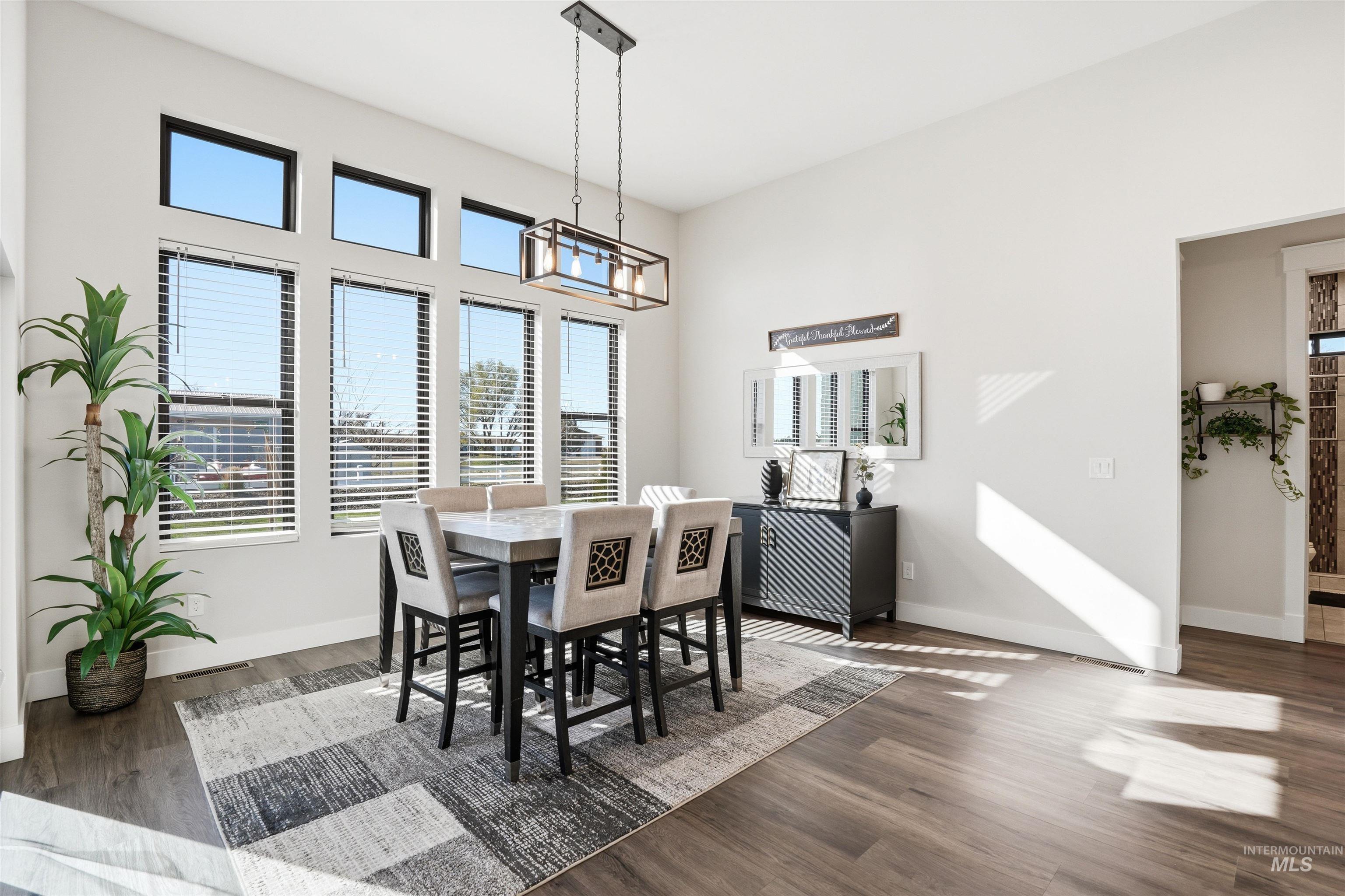 320 West Homedale Road Caldwell, ID 83607 - Photo 12 of 48 Dining space with dark wood-type flooring and a high ceiling