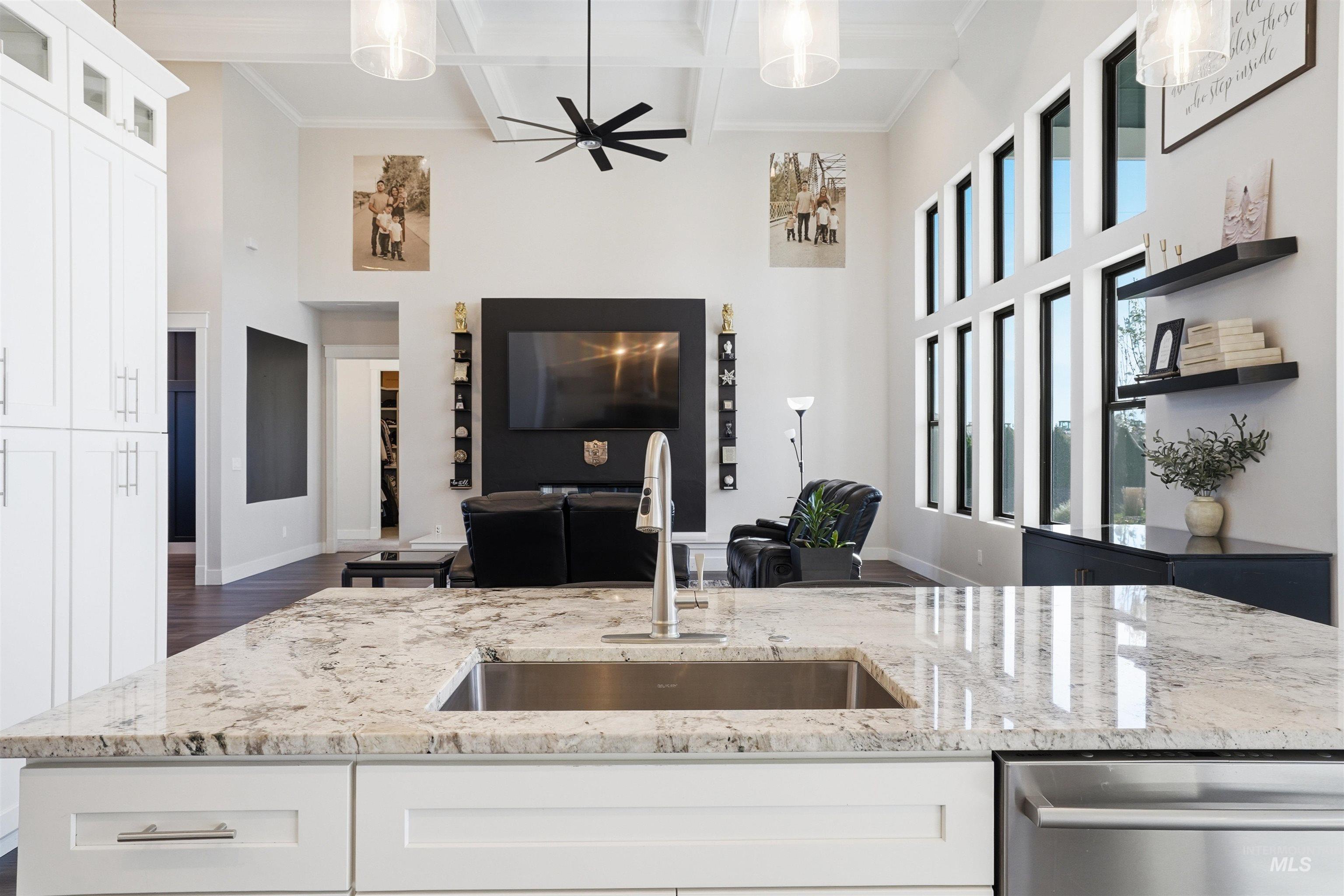 320 West Homedale Road Caldwell, ID 83607 - Photo 47 of 48 Kitchen with white cabinetry, light stone countertops, pendant lighting, open floor plan, and coffered ceiling