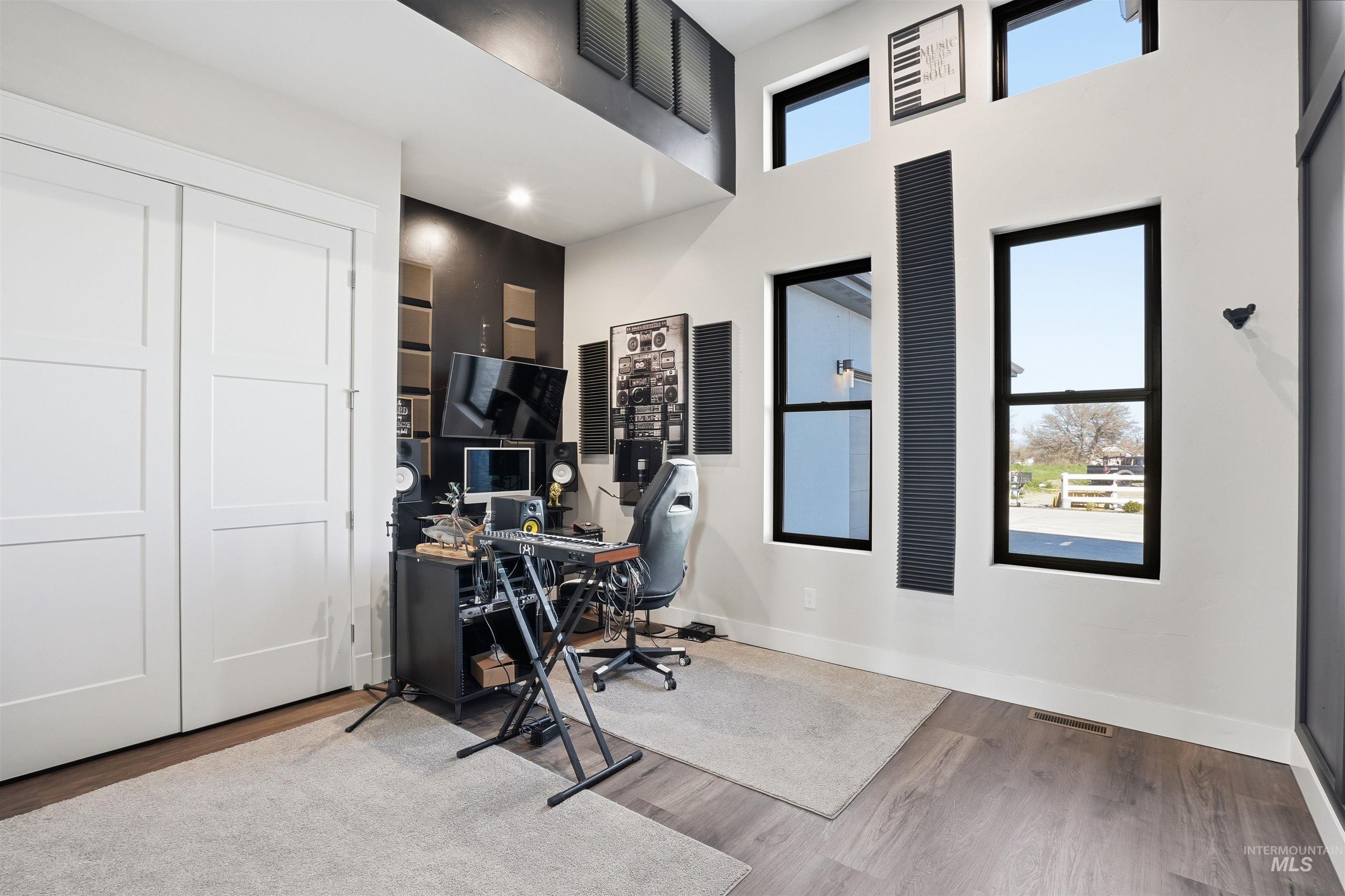 320 West Homedale Road Caldwell, ID 83607 - Photo 23 of 48 Home office featuring light wood-style flooring and a high ceiling
