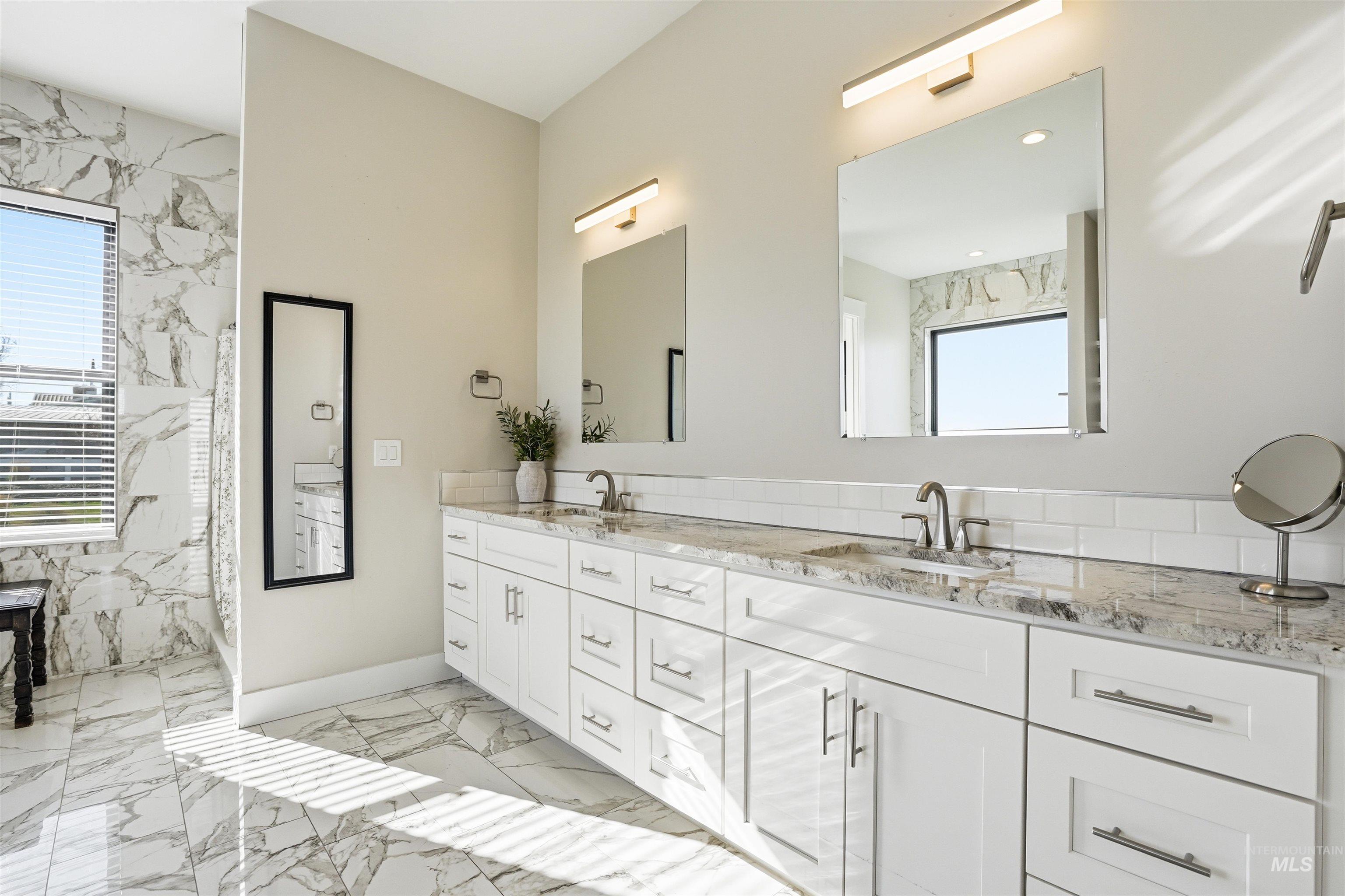 320 West Homedale Road Caldwell, ID 83607 - Photo 29 of 48 Bathroom featuring double vanity, light marble finish floors, and a marble finish shower