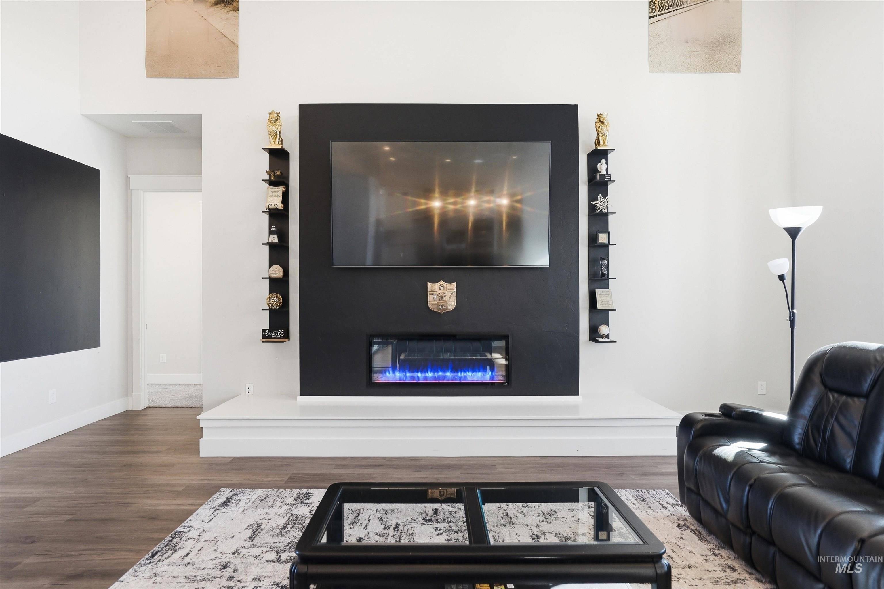 320 West Homedale Road Caldwell, ID 83607 - Photo 8 of 48 Living area with a glass covered fireplace and dark wood-style flooring