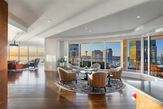 a living room with fireplace furniture and a large window