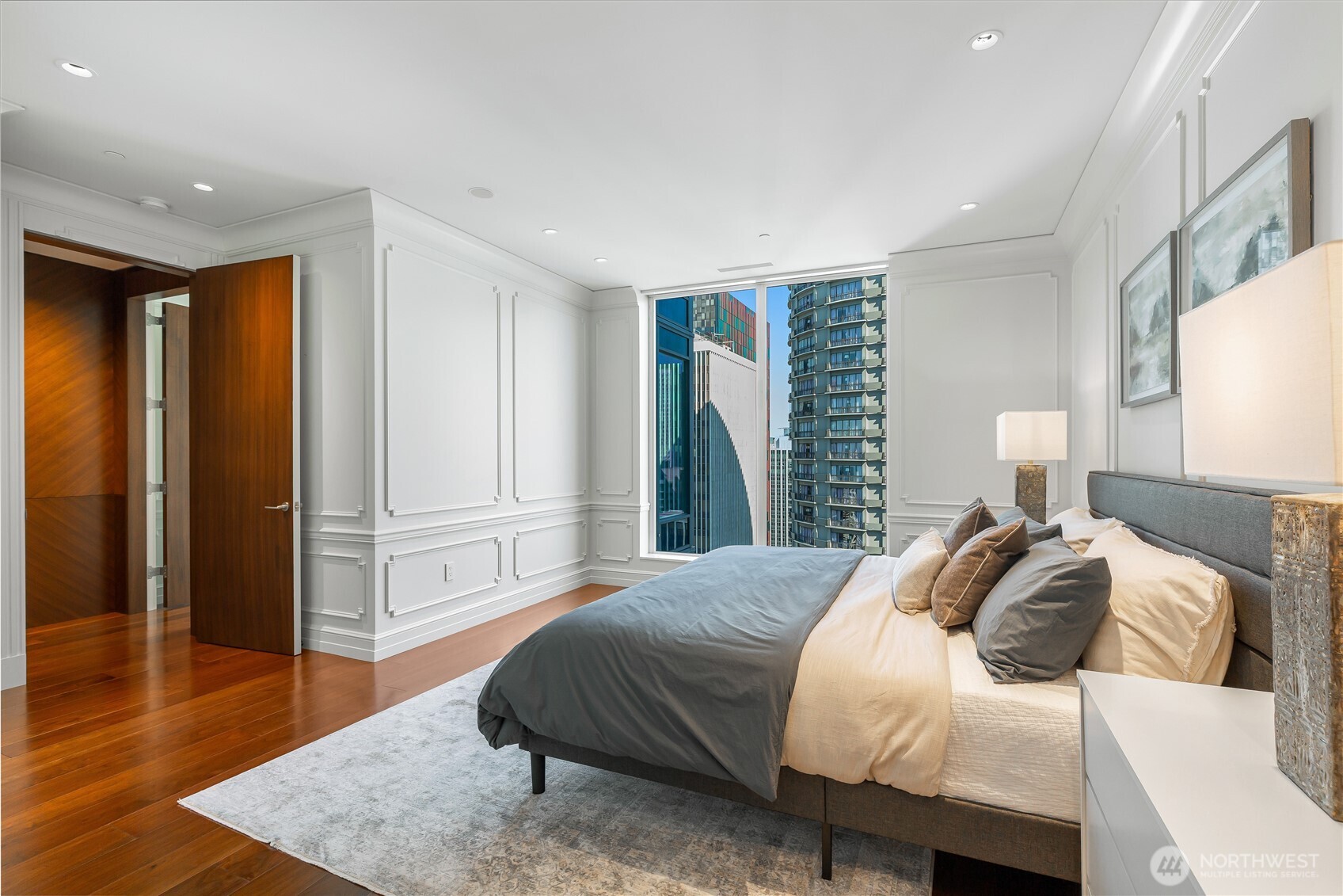 1920 4th Avenue, Unit PH101 Seattle, WA 98101 - Photo 25 of 40 a spacious bedroom with a bed and wooden floor