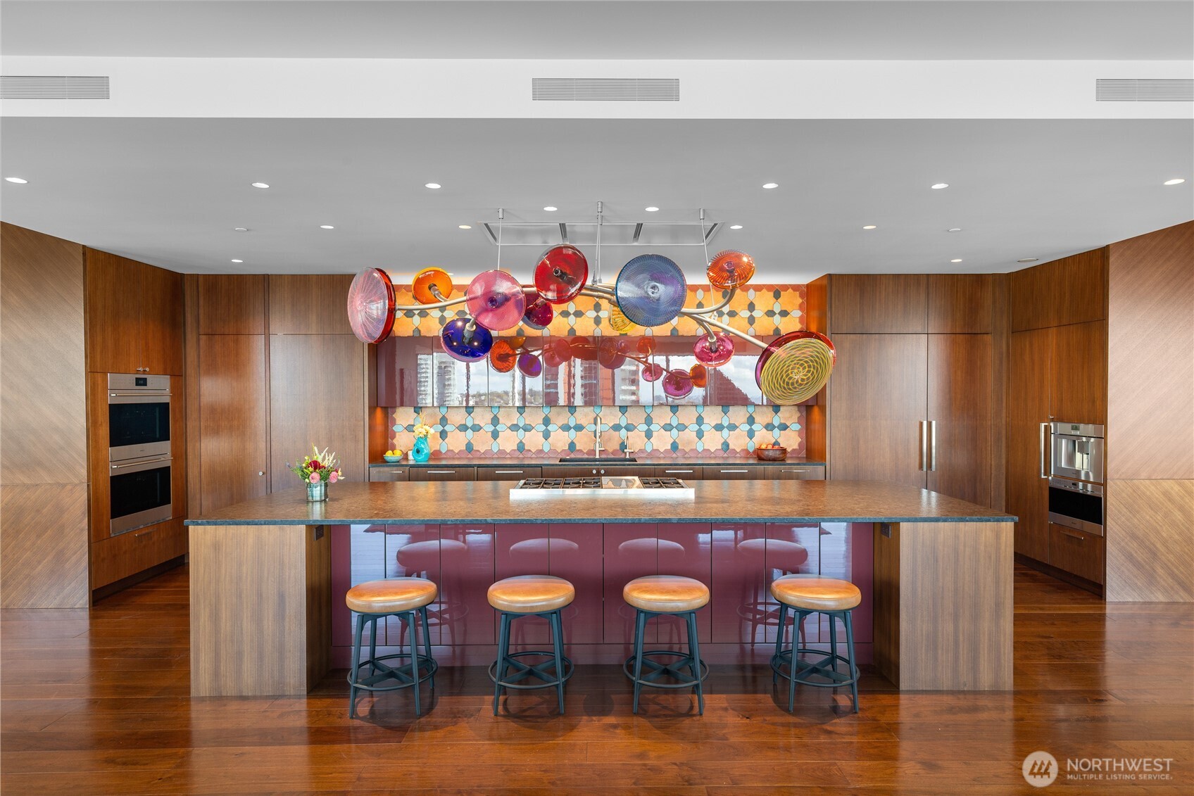 1920 4th Avenue, Unit PH101 Seattle, WA 98101 - Photo 4 of 40 a group of chairs sitting in a kitchen