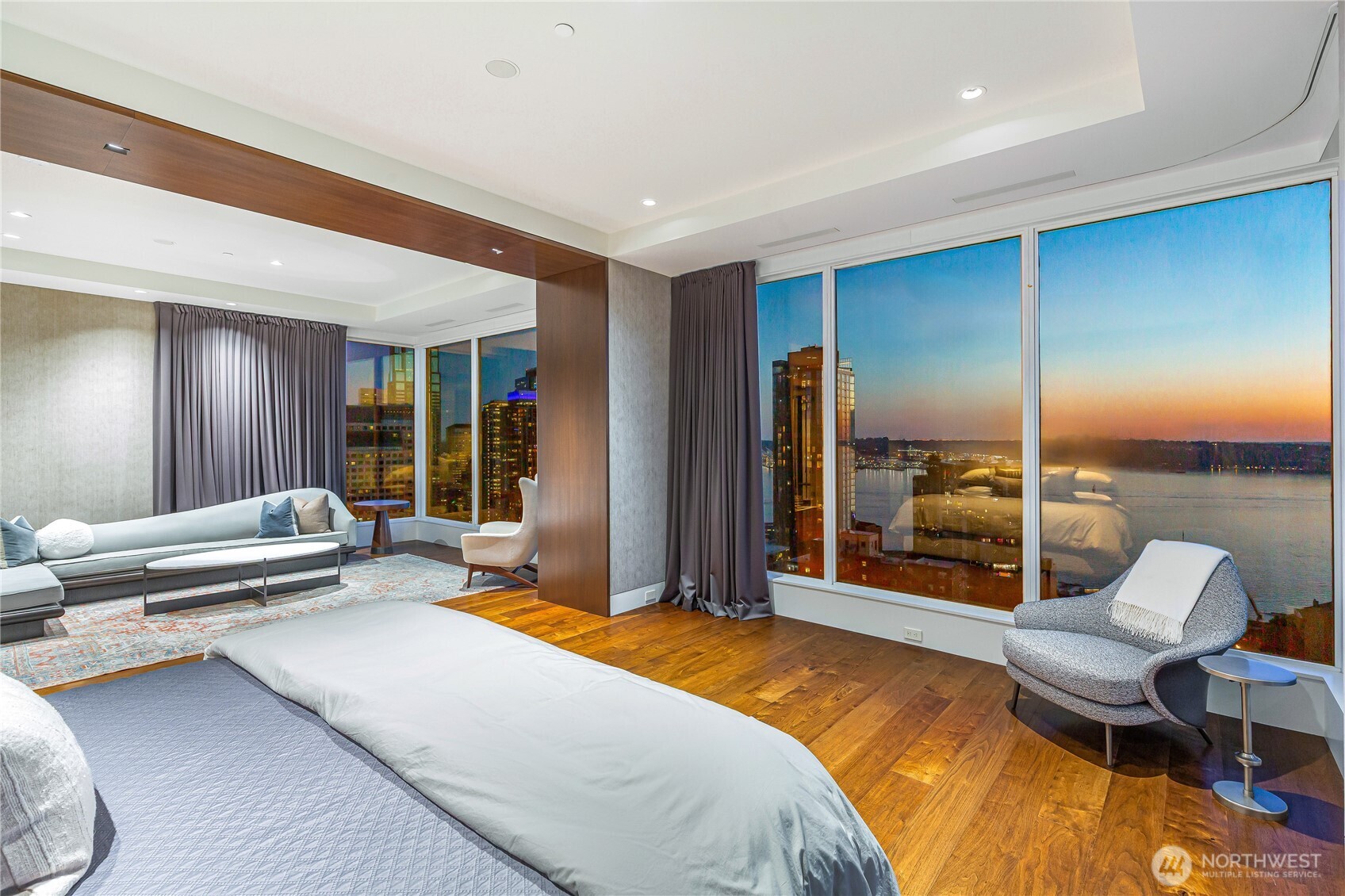 1920 4th Avenue, Unit PH101 Seattle, WA 98101 - Photo 10 of 40 a spacious bedroom with a bed and glass walk in closet