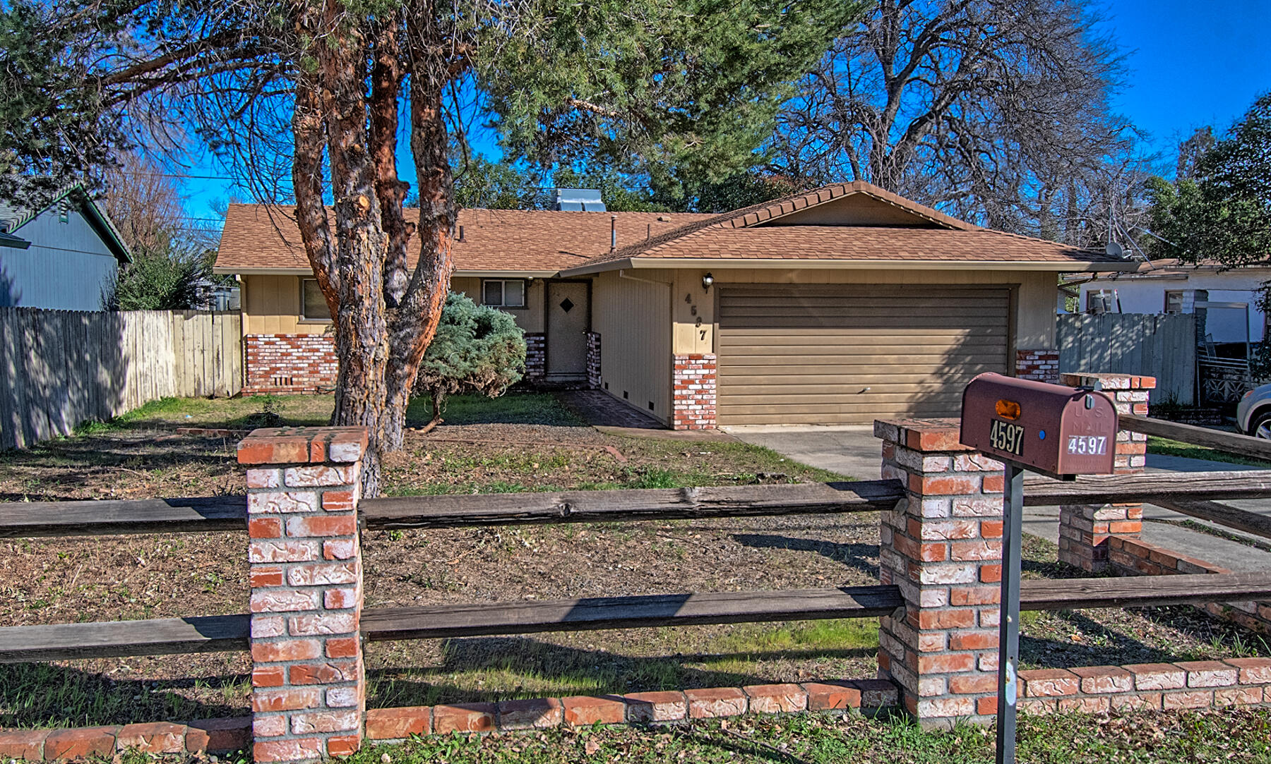 4597 Cedars Road Redding, CA 96001 - Photo 1 of 18 a front view of a house with garden