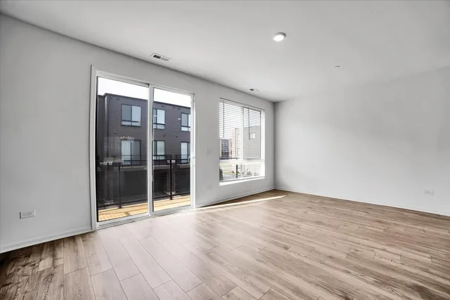 a view of a balcony with wooden floor and door