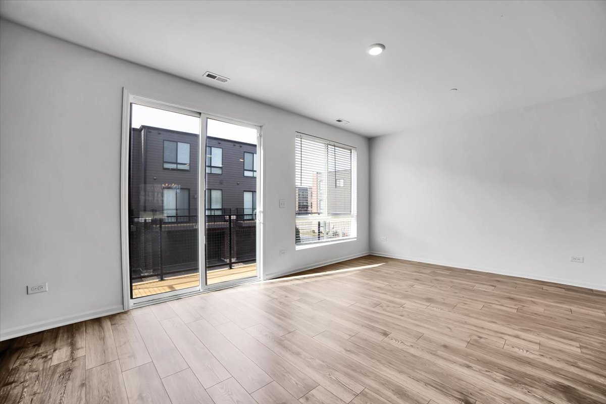 1292 Quadrant Lane Schaumburg, IL 60173 - Photo 12 of 39 wooden floor in an empty room with a window