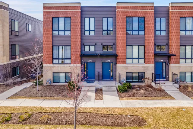 a front view of a building with glass windows and a table