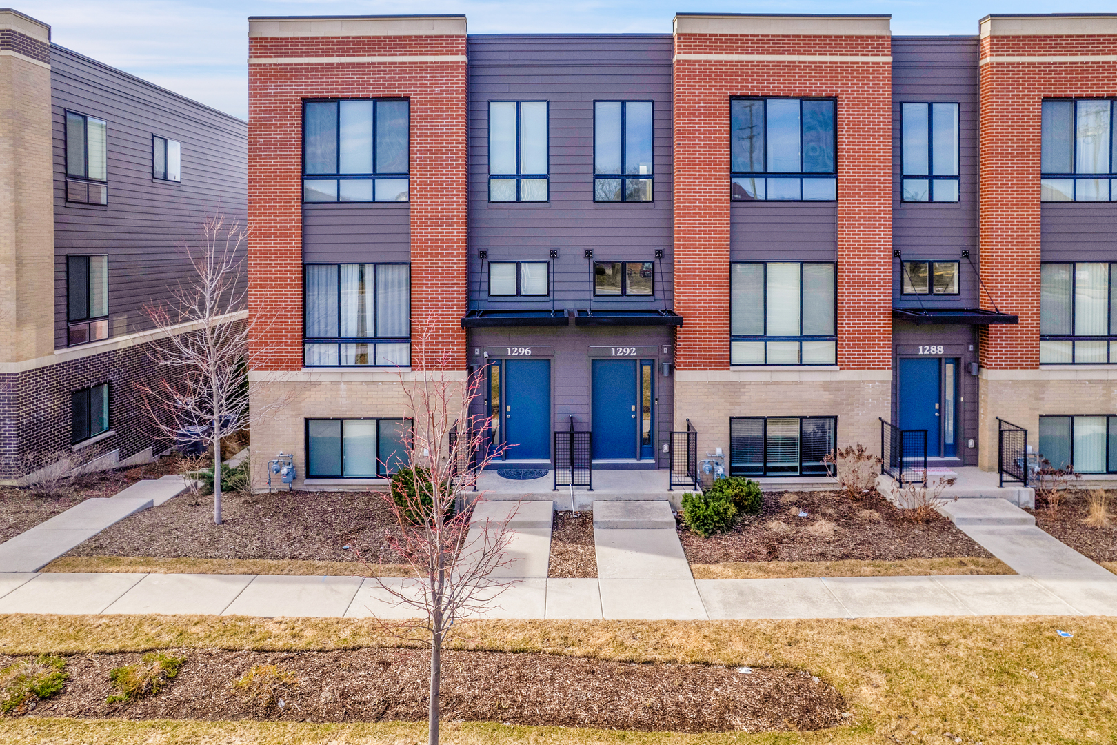 1292 Quadrant Lane Schaumburg, IL 60173 - Photo 2 of 39 a front view of a building with glass windows and a table