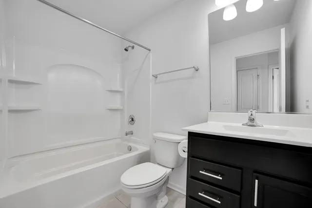 a bathroom with a sink toilet and mirror