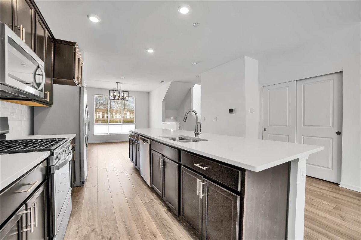 1292 Quadrant Lane Schaumburg, IL 60173 - Photo 5 of 39 a kitchen with kitchen island a sink appliances and cabinets