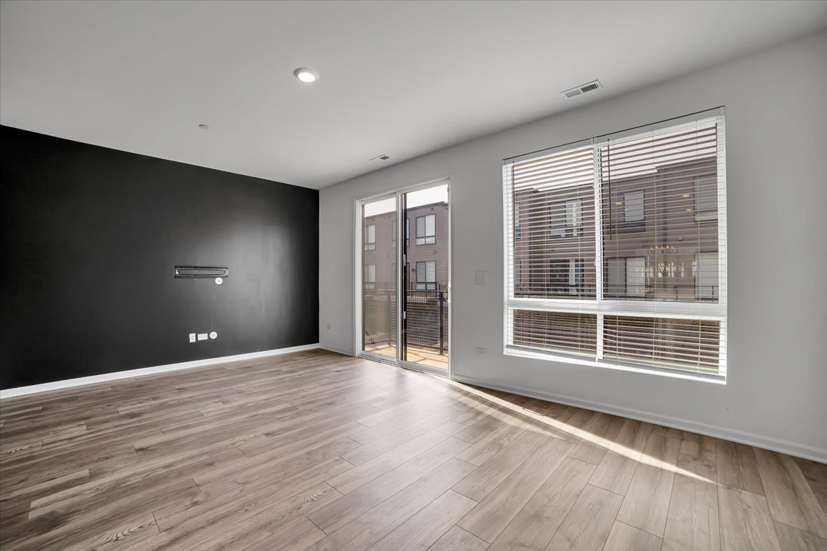 1292 Quadrant Lane Schaumburg, IL 60173 - Photo 10 of 39 a view of empty room with wooden floor and fan