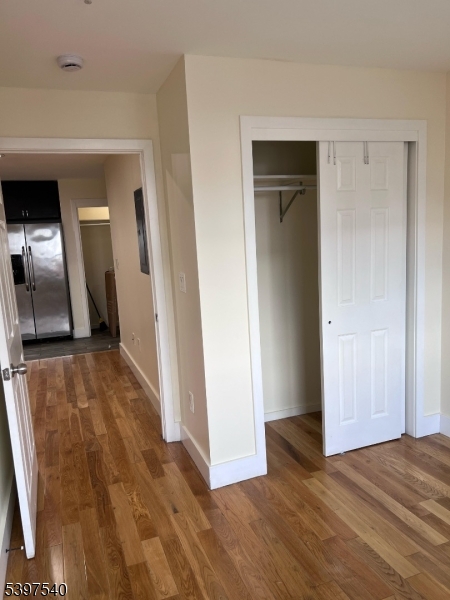 73 Ferry Street, Unit 6 Newark, NJ 07105 - Photo 6 of 7 a view of a hallway to a bedroom with wooden floor and closet