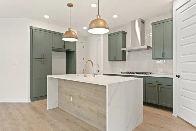 a large white kitchen with a large window appliances and cabinets