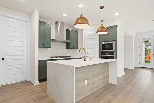 a kitchen with a sink a counter space and a refrigerator