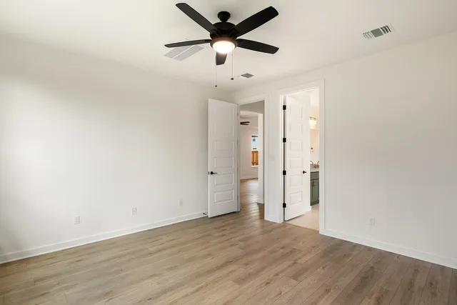 a spacious bathroom with a granite countertop sink mirror and a bathtub