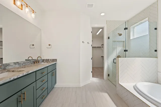 a bathroom with a granite countertop sink double and mirror
