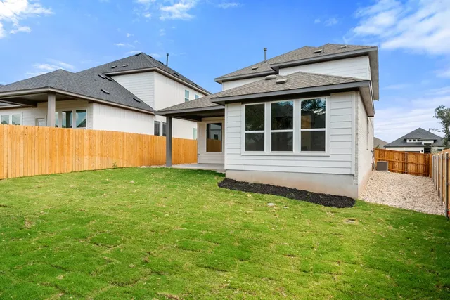 a view of a house with backyard and garden
