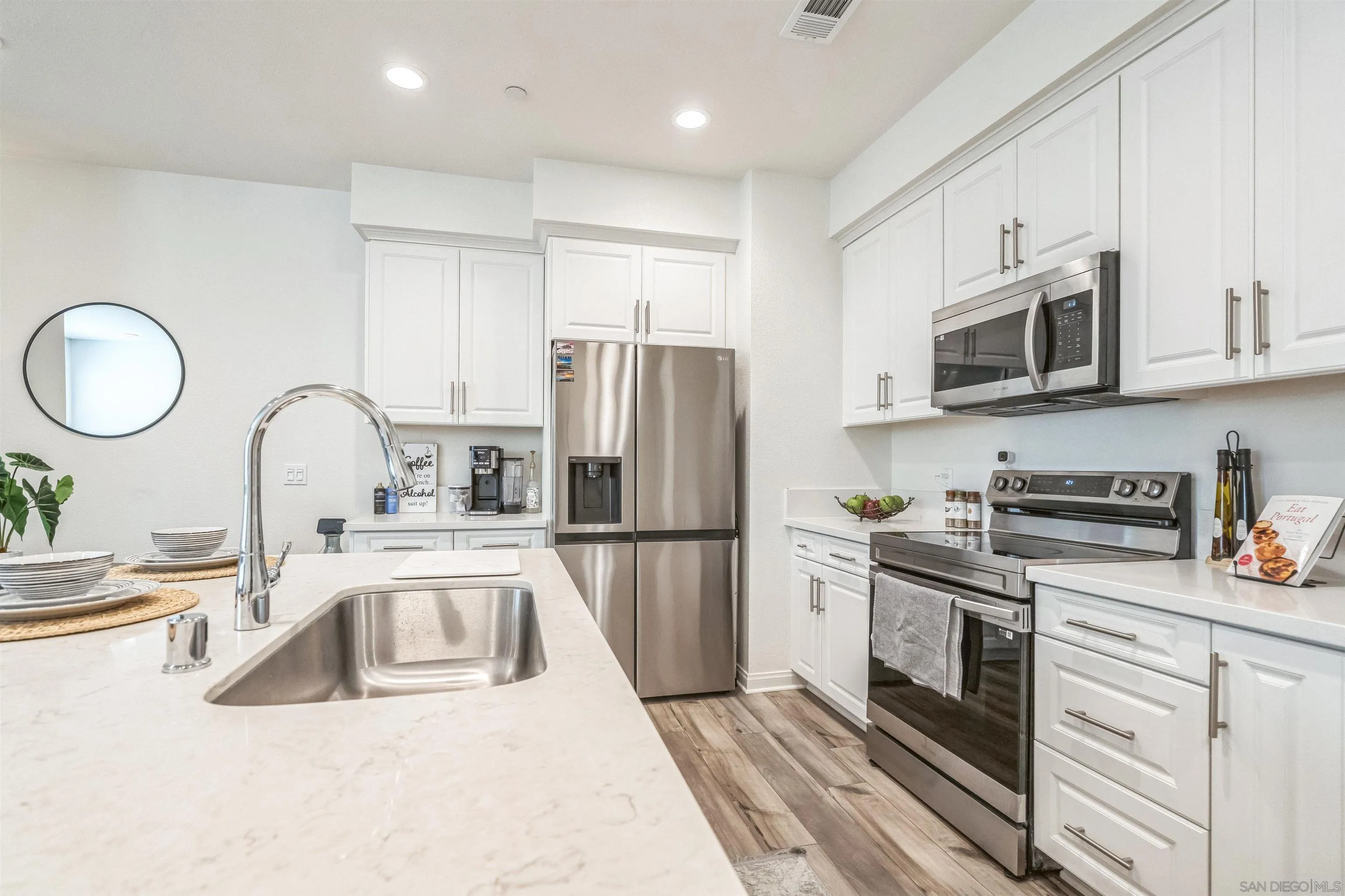 2018 Barite Street Spring Valley, CA 91977 - Photo 12 of 47 a kitchen with a sink stove and refrigerator