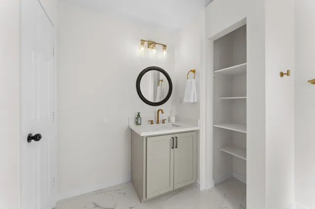 a bathroom with a sink and a mirror