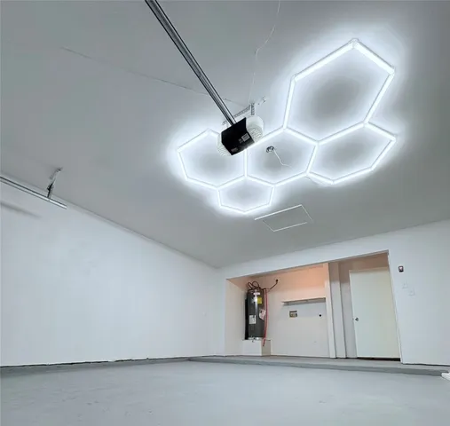 an empty room with a projector & cabinets