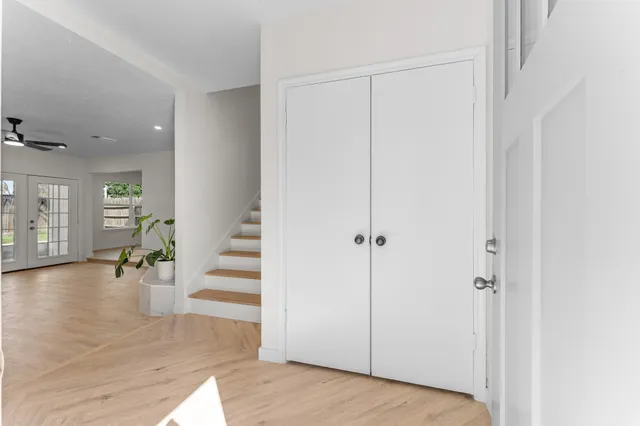 a view of a livingroom with wooden floor and entryway