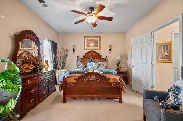 a bedroom with a bed and a chandelier