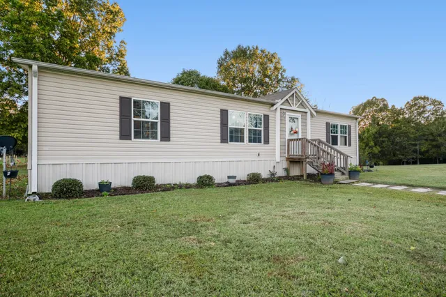 a view of a house with a backyard