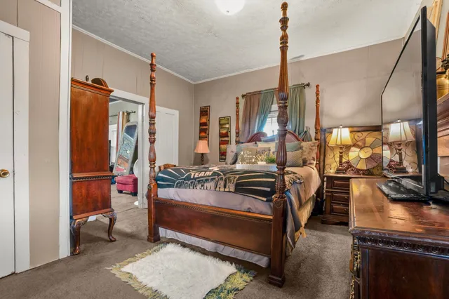 a bedroom with furniture and a large window