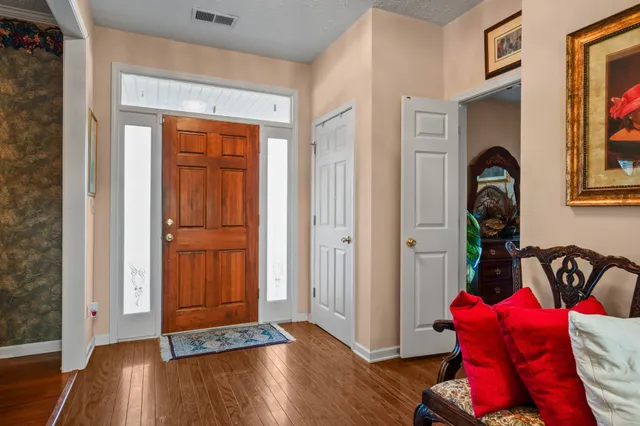 a view of front door with wooden floor