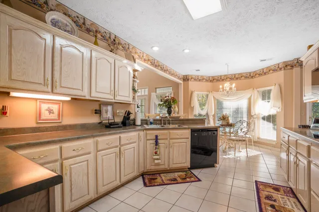 a large kitchen with white cabinets