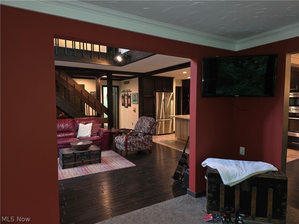 2868 Shade Road Akron, OH 44333 - Photo 21 of 49 Open-concept living area featuring rich wood-finish flooring and a prominent dark wood staircase