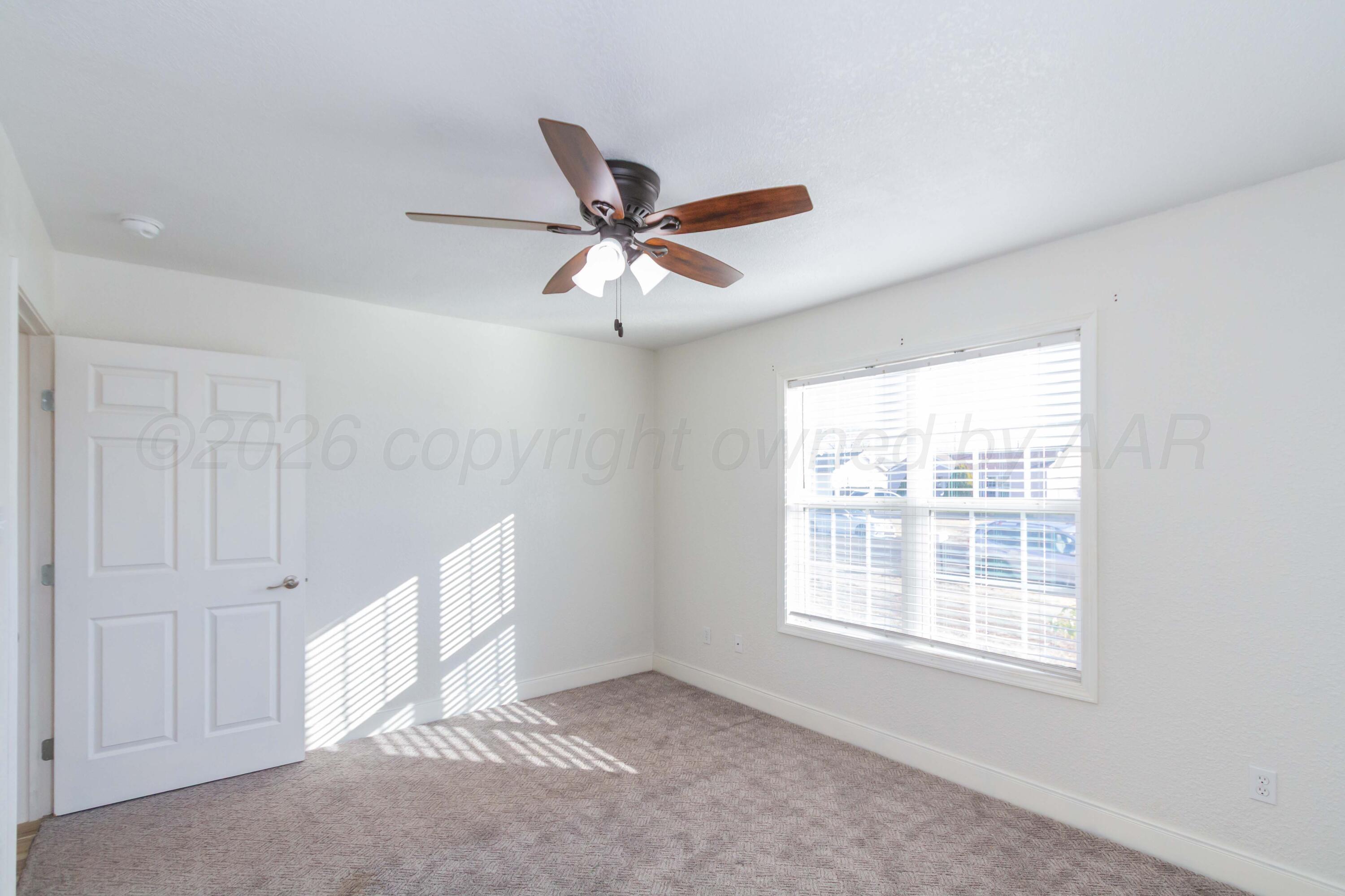 706 Pittsburg Street Amarillo, TX 79104 - Photo 12 of 22 a view of an empty room with a window